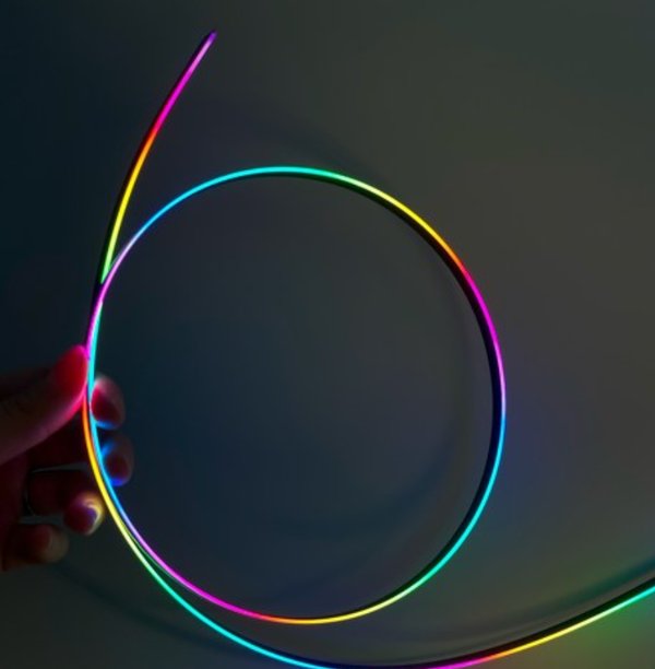 Light guide strip showing rainbow gradient color output from laser-etched micro-structure patterns